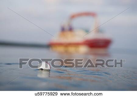 Stock Photo - USA, Missouri, Stockton, Stockton Lake, fishing float on lake. Fotosearch