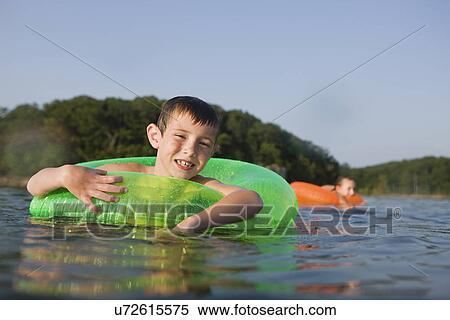 USA, Missouri, Stockton, Stockton Lake, boy (6-7) swimming in inflatable ring View Large Photo Image Stock Photography - USA, Missouri, Stockton, Stockton Lake, boy (6-7) swimming in inflatable ring. Fotosearch