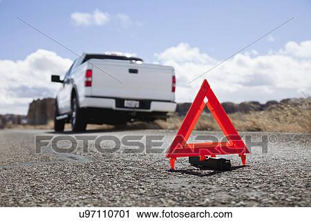 Stock Image - USA, New Mexico, Emergency sign near broken down car in desert. Fotosearch