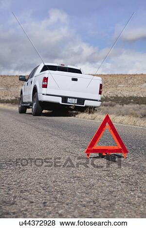 Stock Photo - USA, New Mexico, Emergency sign near broken down car in desert. Fotosearch