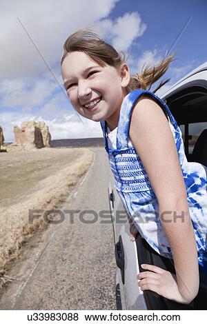 USA, New Mexico, Girl (10-11) leaning out of car window View Large Photo Image Stock Photo - USA, New Mexico, Girl (10-11) leaning out of car window. Fotosearch