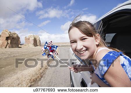 USA, New Mexico, Girl (10-11) waving pinwheel from car window View Large Photo Image Stock Image - USA, New Mexico, Girl (10-11) waving pinwheel from car window. Fotosearch