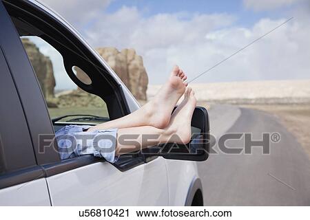 Stock Image - USA, New Mexico, Girl (10-11) with feet out of car window. Fotosearch