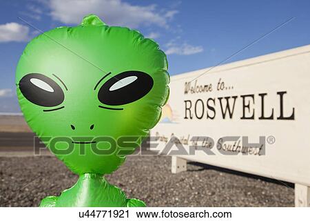 Stock Image - USA, New Mexico, Roswell, Alien by welcome sign. Fotosearch