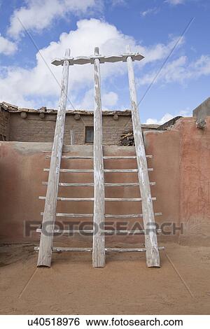 Stock Photograph - USA, New Mexico, Stone house exterior with ladder. Fotosearch