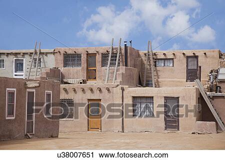 Stock Image - USA, New Mexico, Stone houses in desert. Fotosearch