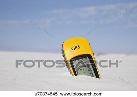 Stock Photography - USA, New Mexico, Whitesands, GPS device buried in sand. Fotosearch