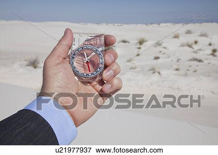 USA, New Mexico, Whitesands, Hand holding compass on desert View Large Photo Image Stock Photo - USA, New Mexico, Whitesands, Hand holding compass on desert. Fotosearch