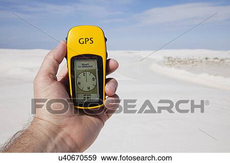 Stock Photo - USA, New Mexico, Whitesands, Hand holding GPS device. Fotosearch