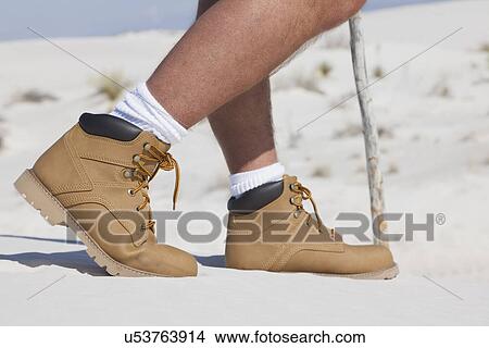 Picture - USA, New Mexico, Whitesands, Low section of man on desert. Fotosearch