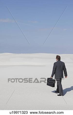 USA, New Mexico, Whitesands, Man wearing suit walking on desert View Large Photo Image Stock Image - USA, New Mexico, Whitesands, Man wearing suit walking on desert. Fotosearch