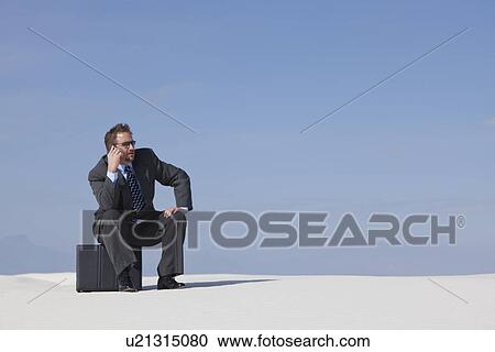 USA, New Mexico, Whitesands, Man wearing suit sitting on desert View Large Photo Image Stock Image - USA, New Mexico, Whitesands, Man wearing suit sitting on desert. Fotosearch