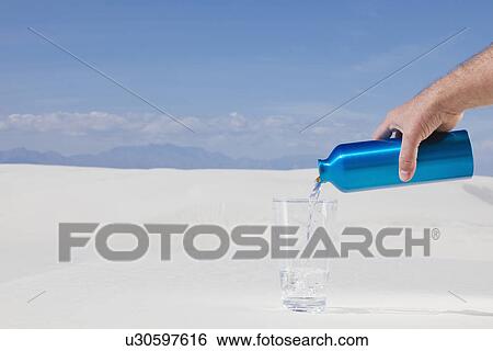 USA, New Mexico, Whitesands, Man pouring water from blue thermos on desert View Large Photo Image Stock Photograph - USA, New Mexico, Whitesands, Man pouring water from blue thermos on desert. Fotosearch