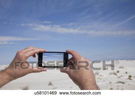 USA, New Mexico, Whitesands, Man taking photo on desert View Large Photo Image Stock Photo - USA, New Mexico, Whitesands, Man taking photo on desert. Fotosearch