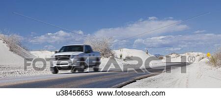 USA, New Mexico, Whitesands, Pick-up truck driving desert road View Large Photo Image Stock Image - USA, New Mexico, Whitesands, Pick-up truck driving desert road. Fotosearch