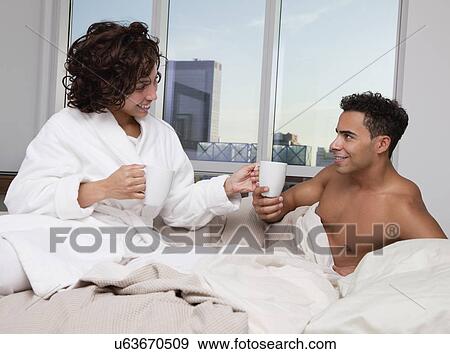 USA, New York City, couple drinking morning coffee in bed View Large Photo Image Stock Photo - USA, New York City, couple drinking morning coffee in bed. Fotosearch
