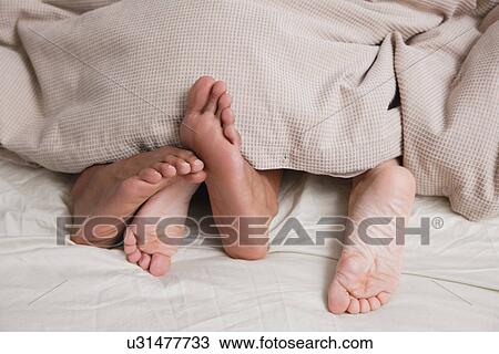 USA, New York City, feet of couple sleeping in bed View Large Photo Image Stock Image - USA, New York City, feet of couple sleeping in bed. Fotosearch