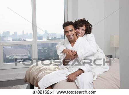 USA, New York City, portrait of couple sitting on bed View Large Photo Image Stock Image - USA, New York City, portrait of couple sitting on bed. Fotosearch