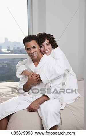 USA, New York City, portrait of couple sitting on bed View Large Photo Image Stock Image - USA, New York City, portrait of couple sitting on bed. Fotosearch
