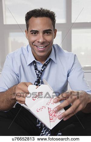USA, New York, New York City, portrait of smiling young man eating Chinise food View Large Photo Image Stock Image - USA, New York, New York City, portrait of smiling young man eating Chinise food. Fotosearch