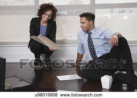 Stock Photo - USA, New York, New York City, businesspeople having meeting in hotel room. Fotosearch