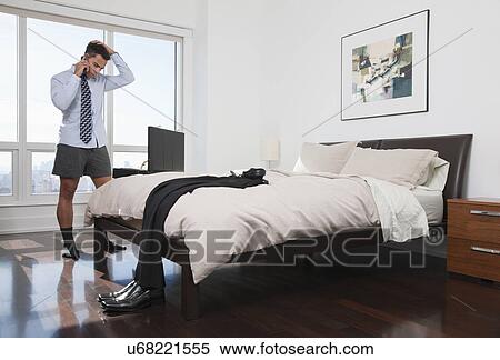 USA, New York, New York City, stressed man talking on mobile phone in hotel room View Large Photo Image Stock Photography - USA, New York, New York City, stressed man talking on mobile phone in hotel room. Fotosearch