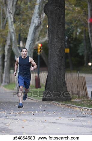 USA, New York, New York City, Young man jogging in park View Large Photo Image Stock Image - USA, New York, New York City, Young man jogging in park. Fotosearch