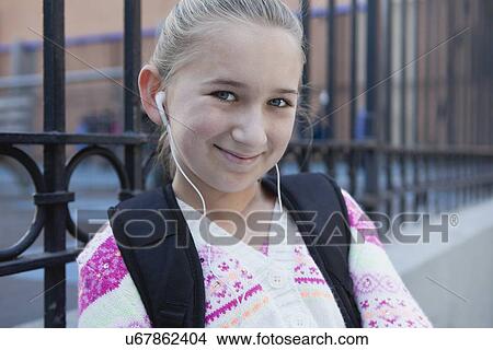 Picture - USA, New York State, New York City, Portrait of girl (10-11) with earphones . Fotosearch