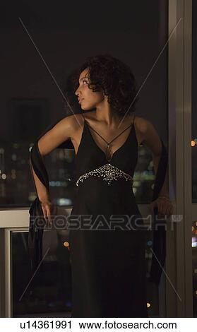 USA, New York State, New York City, young woman wearing dress by window View Large Photo Image Stock Image - USA, New York State, New York City, young woman wearing dress by window. Fotosearch