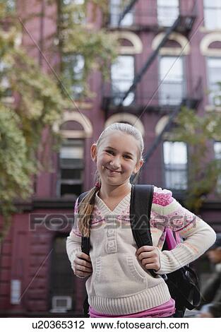 Stock Image - USA, New York State, New York City, Portrait of girl (10-11) with backpack . Fotosearch