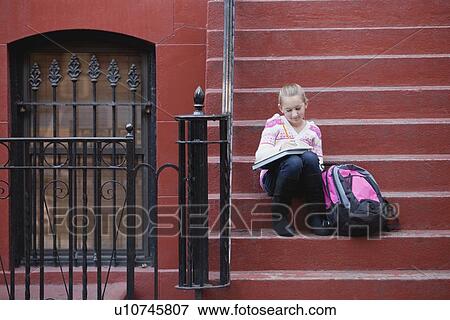 USA, New York State, New York City, Girl (10-11) doing homework while sitting on steps View Large Photo Image Stock Photo - USA, New York State, New York City, Girl (10-11) doing homework while sitting on steps. Fotosearch