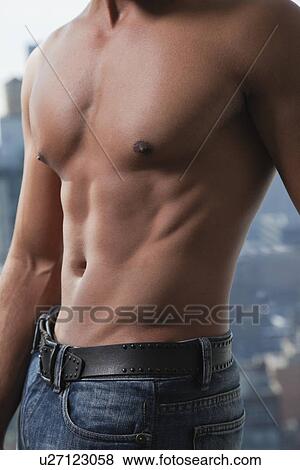 Stock Photo - USA, New York State, New York City, young mans chest. Fotosearch