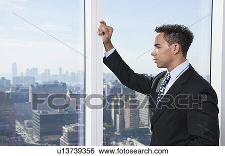 USA, New York State, New York City, business man looking through window View Large Photo Image Stock Photograph - USA, New York State, New York City, business man looking through window. Fotosearch