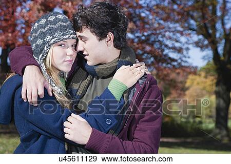USA, Pennsylvania, Doylestown, teenage couple (16-17) embracing in park View Large Photo Image Stock Photo - USA, Pennsylvania, Doylestown, teenage couple (16-17) embracing in park. Fotosearch