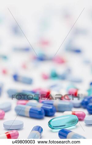 Stock Image - Variety of pills and capsules on white background, studio shot. Fotosearch
