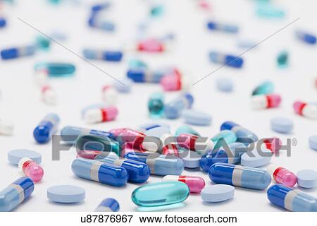 Stock Photo - Variety of pills and capsules on white background, studio shot. Fotosearch