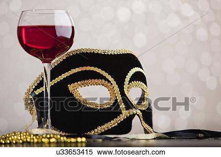 Stock Photography - Venetian mask and glass of red wine. Fotosearch