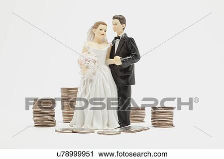 Wedding figurines and stacks of coins, studio shot View Large Photo Image Stock Image - Wedding figurines and stacks of coins, studio shot. Fotosearch