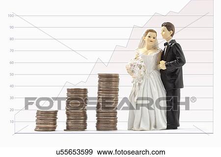 Wedding figurines and stacks of coins View Large Photo Image Stock Photo - Wedding figurines and stacks of coins. Fotosearch