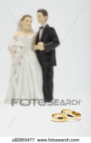 Stock Photo - Wedding figurines and wedding rings, studio shot. Fotosearch