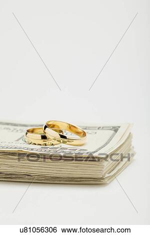 Wedding ring son bunch of dollar banknotes, studio shot View Large Photo Image Stock Photograph - Wedding ring son bunch of dollar banknotes, studio shot. Fotosearch