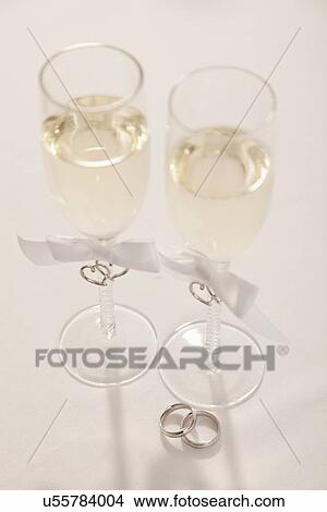 Wedding rings and champagne flutes View Large Photo Image Picture - Wedding rings and champagne flutes . Fotosearch