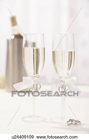 Wedding rings and champagne flutes View Large Photo Image Stock Photo - Wedding rings and champagne flutes . Fotosearch