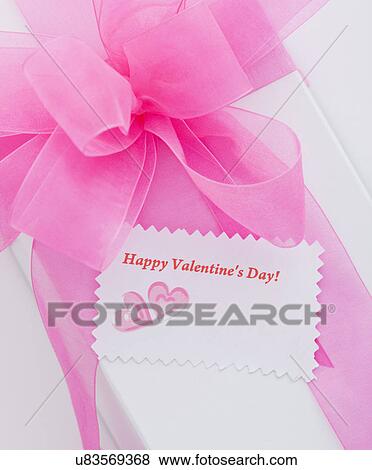 Stock Photo - White box with pink ribbon and Valentine's Day greeting card. Fotosearch