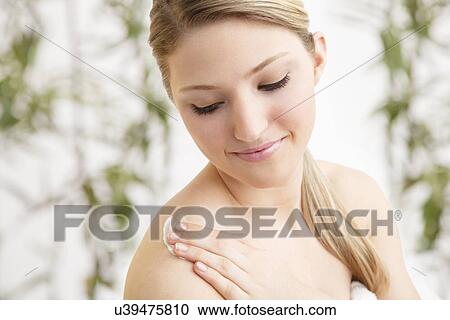 Woman applying moisturizer View Large Photo Image Stock Image - Woman applying moisturizer. Fotosearch