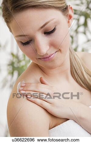 Stock Photograph - Woman applying moisturizer. Fotosearch