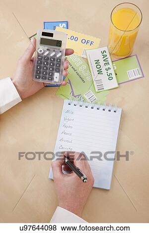 Stock Photo - Woman doing shopping list. Fotosearch