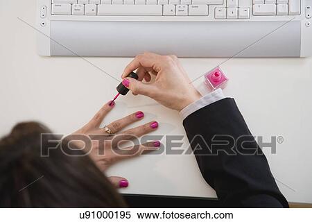 Woman painting nails near computer keyboard View Large Photo Image Stock Photography - Woman painting nails near computer keyboard. Fotosearch