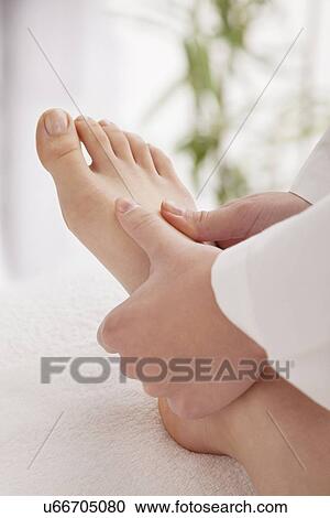 Stock Image - Woman receiving foot massage. Fotosearch