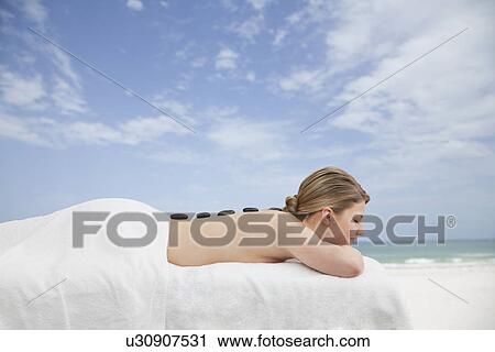 Woman receiving la stone therapy View Large Photo Image Stock Image - Woman receiving la stone therapy. Fotosearch